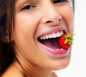 Woman eating strawberry