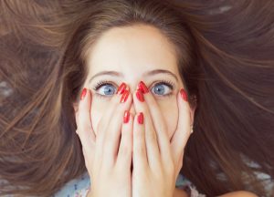 Shamed cute girl with red nails